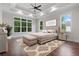 Spacious main bedroom features a tray ceiling, large windows with wooded views, and stylish decor at 101 Forsyth Park Ln, Woodstock, GA 30188