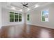 Bright primary bedroom with tray ceiling, hardwood floor, and serene outdoor views at 101 Forsyth Park Ln, Woodstock, GA 30188