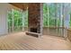 Inviting outdoor fireplace on wooden deck overlooking a serene wooded area at 101 Forsyth Park Ln, Woodstock, GA 30188