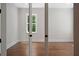 Neutral room with hardwood floors seen through a set of french doors at 101 Forsyth Park Ln, Woodstock, GA 30188