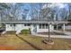 Charming ranch home with light brick exterior, landscaped yard, and attached carport at 1832 Wee Kirk Se Rd, Atlanta, GA 30316