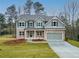 Two-story home with a brick facade, neutral paint, a two-car garage and manicured lawn at 1020 Cottonwood Ln, Loganville, GA 30052