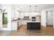 Modern kitchen with white cabinets, stainless appliances, and dark island at 1020 Cottonwood Ln, Loganville, GA 30052
