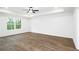 Spacious main bedroom with tray ceiling, ceiling fan, and large window at 1020 Cottonwood Ln, Loganville, GA 30052