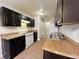 Galley kitchen with dark cabinets and tiled floors at 5117 Panola Valley Dr, Lithonia, GA 30038