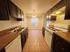Eat-in kitchen, dark cabinets, tiled floor, and window at 5117 Panola Valley Dr, Lithonia, GA 30038