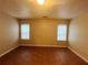 Living room with tile floors and two windows at 5117 Panola Valley Dr, Lithonia, GA 30038