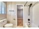 Bathroom with shower, white tile, matte black shower fixtures and a window at 6360 Ashdale Dr, Atlanta, GA 30349