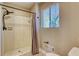 Bathroom shower with tan tile, bronze fixtures, hexagon floor and beige walls at 6360 Ashdale Dr, Atlanta, GA 30349