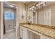Bathroom with granite countertop, double sinks, and modern fixtures at 6360 Ashdale Dr, Atlanta, GA 30349
