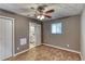 Bedroom with ceiling fan, small window and doorway to a bathroom at 6360 Ashdale Dr, Atlanta, GA 30349