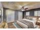 Primary bedroom featuring a large window, carpet, and a ceiling fan at 6360 Ashdale Dr, Atlanta, GA 30349