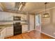 Functional kitchen with tiled backsplash, modern appliances, and overhead lighting at 6360 Ashdale Dr, Atlanta, GA 30349