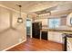 Kitchen with white cabinets, hardwood floors, and modern lighting at 6360 Ashdale Dr, Atlanta, GA 30349