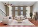 Cozy living room with hardwood floors, many windows, and neutral furnishings at 6360 Ashdale Dr, Atlanta, GA 30349