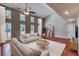 Bright living room with vaulted ceiling, multiple windows, and hardwood floors at 6360 Ashdale Dr, Atlanta, GA 30349