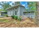Side view of the gray home showcasing well-maintained landscaping with vibrant purple flowers at 6360 Ashdale Dr, Atlanta, GA 30349