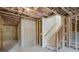 Unfinished basement with exposed beams, stairs, and concrete flooring ready for customization at 7256 Eton Ln, Locust Grove, GA 30248