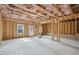 Unfinished basement with concrete flooring, exposed beams, and window for natural light at 7256 Eton Ln, Locust Grove, GA 30248