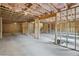 Spacious unfinished basement with exposed wood and concrete floor, ready for customization at 7256 Eton Ln, Locust Grove, GA 30248