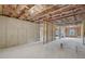 Unfinished basement with concrete floors, exposed insulation, and natural light from the windows at 7256 Eton Ln, Locust Grove, GA 30248
