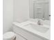 Bright bathroom featuring a white single sink vanity and a framed mirror reflecting the shower at 7256 Eton Ln, Locust Grove, GA 30248