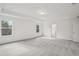 Large bedroom with plush carpeting, tray ceilings, and natural lighting at 7256 Eton Ln, Locust Grove, GA 30248