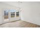 Dining room with door leading to deck, neutral walls, and chandelier at 7256 Eton Ln, Locust Grove, GA 30248