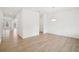 Bright dining room featuring hardwood floors, white walls, and modern pendant lighting at 7256 Eton Ln, Locust Grove, GA 30248