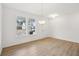 Bright entryway with hardwood floors, pendant lighting, and large windows at 7256 Eton Ln, Locust Grove, GA 30248
