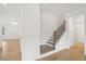 Bright entryway featuring hardwood floors, white walls, and a staircase with rod iron railing at 7256 Eton Ln, Locust Grove, GA 30248
