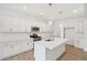 Modern kitchen featuring white cabinets, an island with sink, and stainless steel appliances at 7256 Eton Ln, Locust Grove, GA 30248