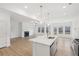 Open-concept kitchen featuring a kitchen island, stainless steel appliances, and natural light at 7256 Eton Ln, Locust Grove, GA 30248