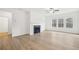 Living room with fireplace, hardwood floors, and natural light at 7256 Eton Ln, Locust Grove, GA 30248