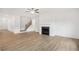 Bright living room with fireplace, hardwood floors, and an open layout with natural light at 7256 Eton Ln, Locust Grove, GA 30248