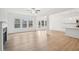 Spacious living space with hardwood floors, fireplace, natural light, and an open floorplan at 7256 Eton Ln, Locust Grove, GA 30248