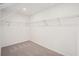 Walk-in closet featuring neutral carpet and metal shelving at 7256 Eton Ln, Locust Grove, GA 30248