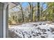Partially snow covered backyard with mature trees at 2280 Connally Ct, Atlanta, GA 30344