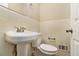 Clean bathroom with white pedestal sink and toilet at 2280 Connally Ct, Atlanta, GA 30344