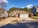 Charming house with two-car garage and lush green landscaping at 3062 Woodbridge Ln, Canton, GA 30114