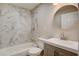 Modern bathroom featuring marble tile and updated vanity at 16 S Eugenia Nw Pl, Atlanta, GA 30318