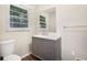 Clean bathroom with gray vanity and new flooring at 2456 Colorado Sw Trl, Atlanta, GA 30331