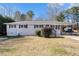 Simple ranch home with neutral paint, landscaping, and carport at 2456 Colorado Sw Trl, Atlanta, GA 30331