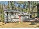 Ranch style home with gray exterior, red door, and landscaped yard at 2456 Colorado Sw Trl, Atlanta, GA 30331