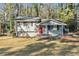 Front view of charming house with red door and yard at 2456 Colorado Sw Trl, Atlanta, GA 30331