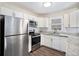Updated kitchen with white cabinets, granite countertops, and stainless steel appliances at 2456 Colorado Sw Trl, Atlanta, GA 30331