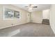 Living room with carpet, large window, and access to stairs at 2456 Colorado Sw Trl, Atlanta, GA 30331