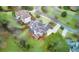 Aerial view of a large house with a deck, situated in a quiet, tree-lined neighborhood at 5060 Rosedown Pl, Roswell, GA 30076