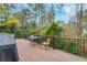 Deck with composite wood and black metal railings, overlooking a wooded area at 5060 Rosedown Pl, Roswell, GA 30076