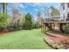 Landscaped backyard with deck and patio, offering ample outdoor space at 5060 Rosedown Pl, Roswell, GA 30076